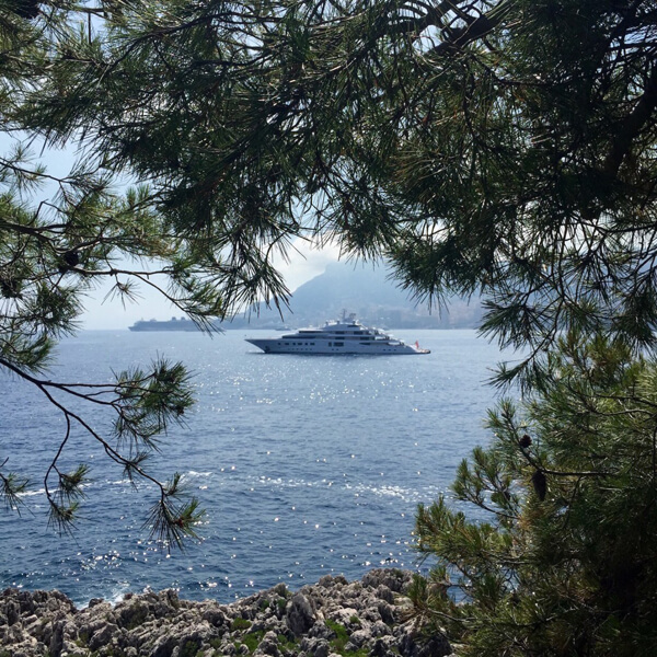View of a superyacht with Monaco in the distance