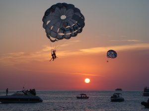 Couple parasailing during Ibiza sunset