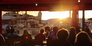 Guests at Cafe enjoying sunset over St Tropez