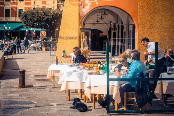 Couples dining outside at Portofino restaurant in sun