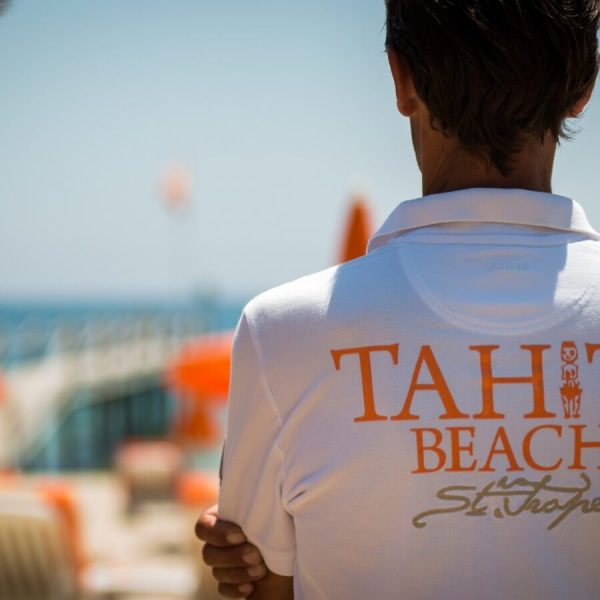 Member of staff in white Tahiti Beach polo shirt. St Tropez
