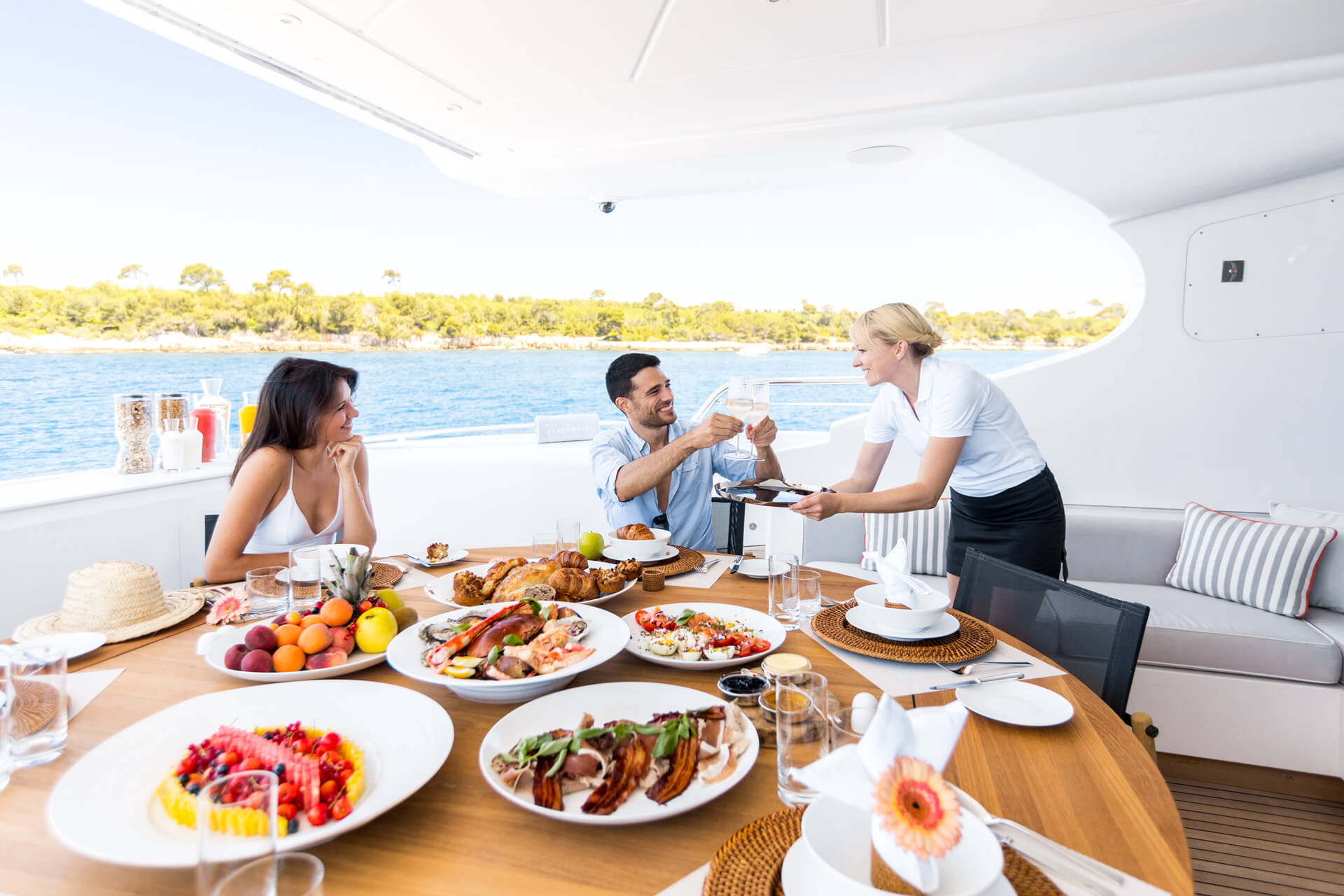 Couple dining on aft deck, Beachouse Mangusta 130 yacht