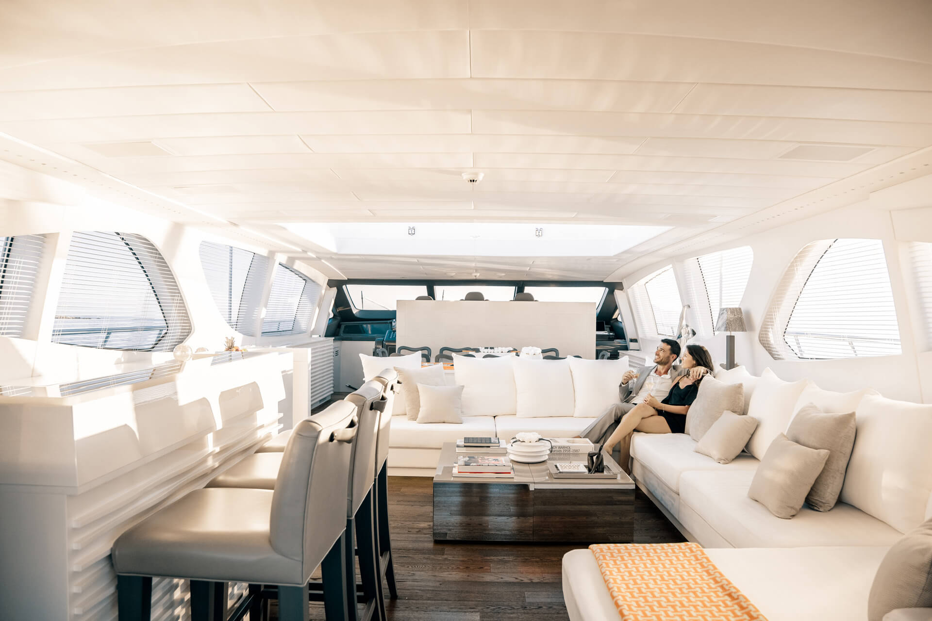Couple relax in internal lounge, Beachouse Mangusta 130 yacht