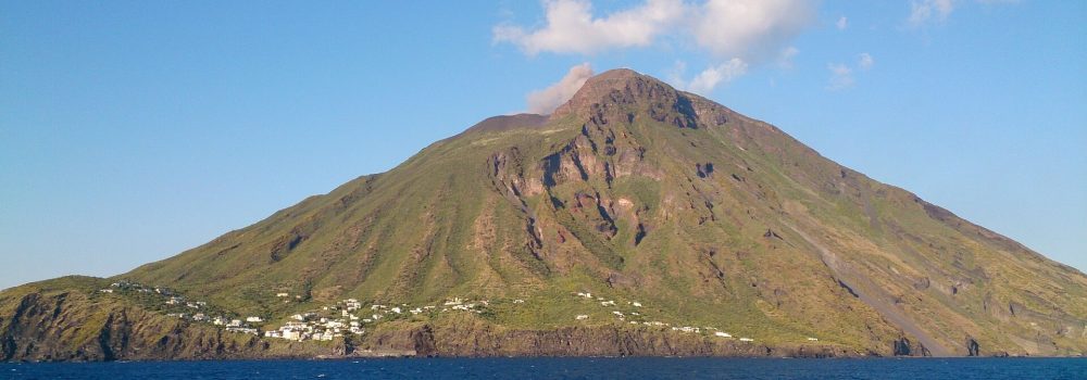 Stromboli Island rises out of the blue sea below