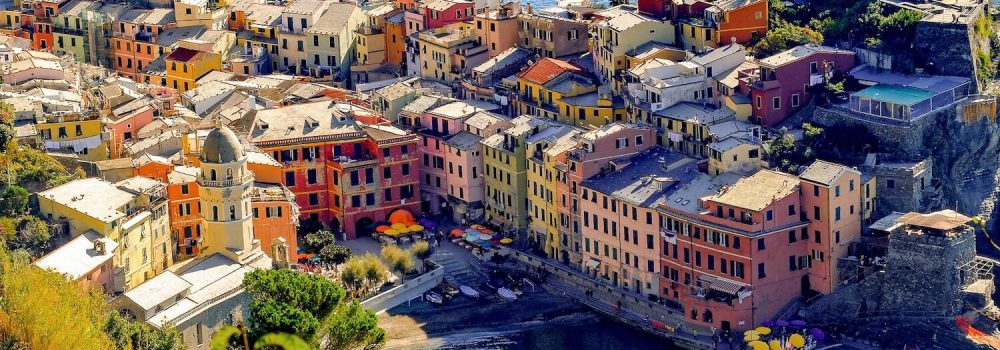 Aerial image of buildings surrouding the small port of Vernazza, Italy